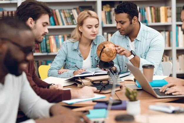 Making Use of Knowledge A diverse group of young adults collaborating in a library,